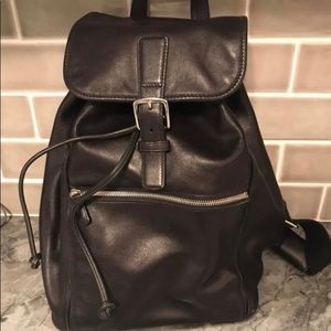 Coach cinch top backpack with buckle clasp.